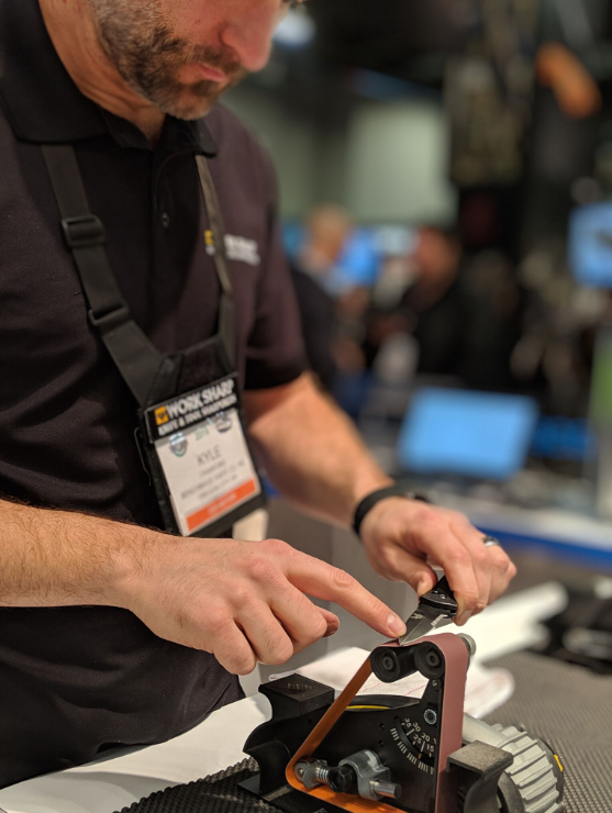 Kyle Crawford the Work Sharp Outdoor brand manager sharpens a pocket knife on the Blade Grinding Attachment at 20 degrees